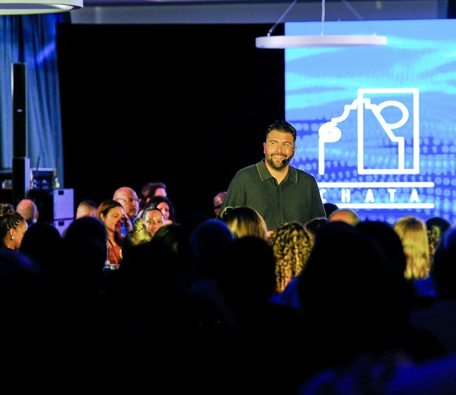 Speaker addressing a full room of attendees at a B2B conference